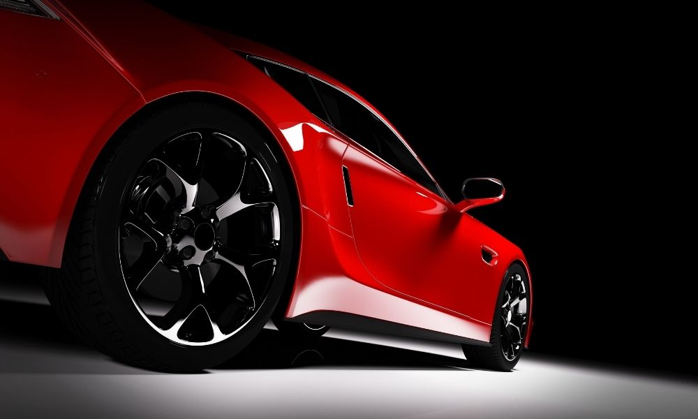 A brand new sports car on a showroom floor. The image has dramatic lighting.